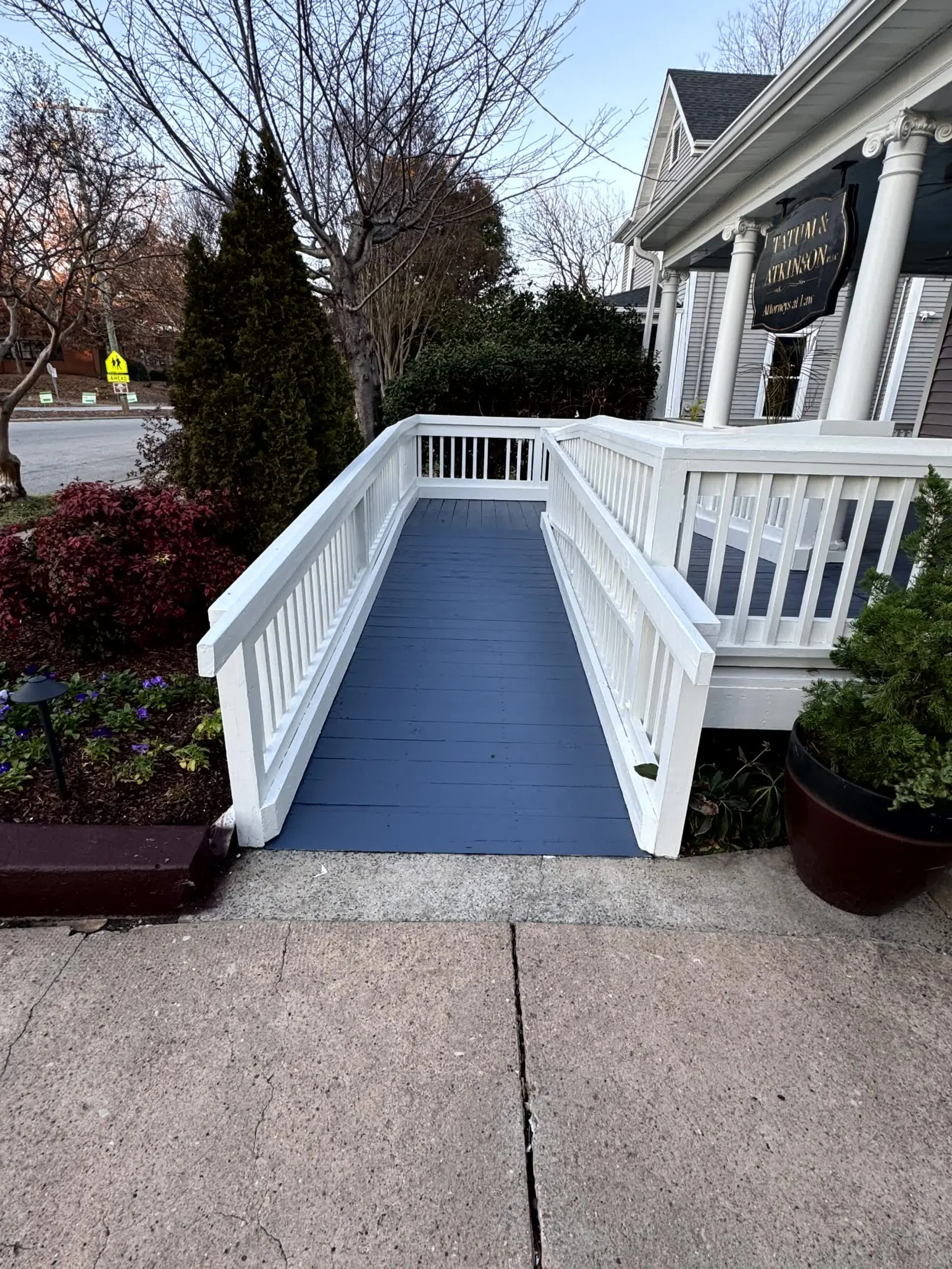 Freshly painted white and blue wooden ramp with clean lines and crisp finish – professional deck painting in Clayton, NC.